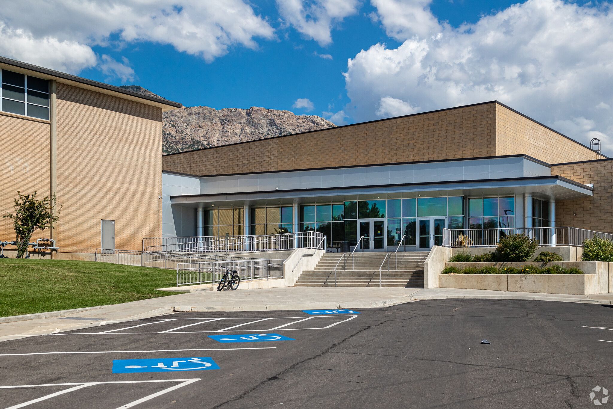 side parking lot with windows and a wheekchair ramp