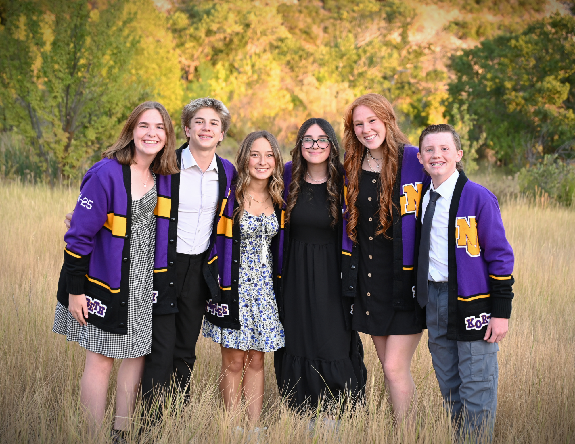  6 9th grade officers in a field with purple jackets