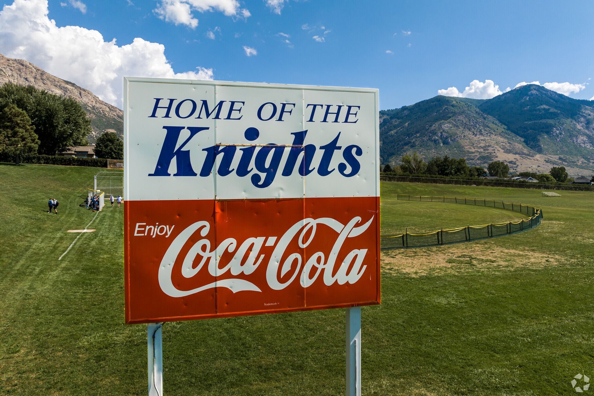 a vintage home of the knights cococola sign over the baseball field